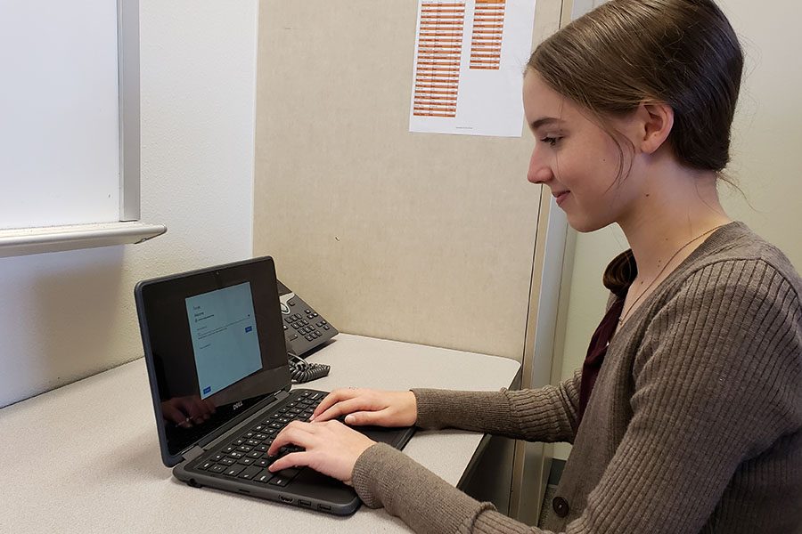 Freshman Anna Yates works on a Chromebook