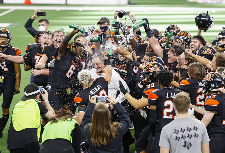 Aledo football players douse head coach Tim Buchanan in water after winning their 10th state championship title against Crosby on Jan. 15.