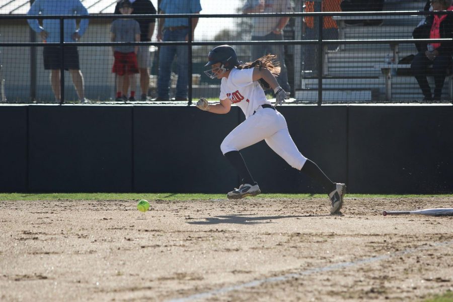 Junior shortstop, #1, Macy Graf runs to first base after recording a hit.