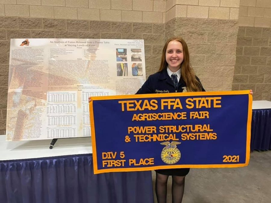 Senior+Gabby+Shultz+holds+her+first+place+banner+at+the+Agriscience+Fair.+