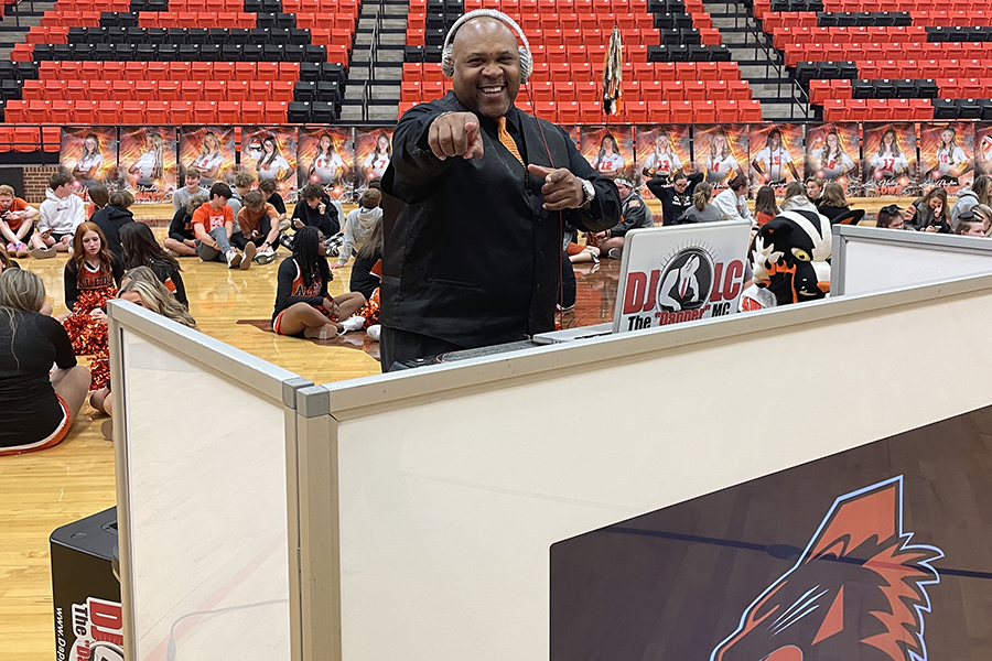 The DJ at the pep rally hypes up students. 