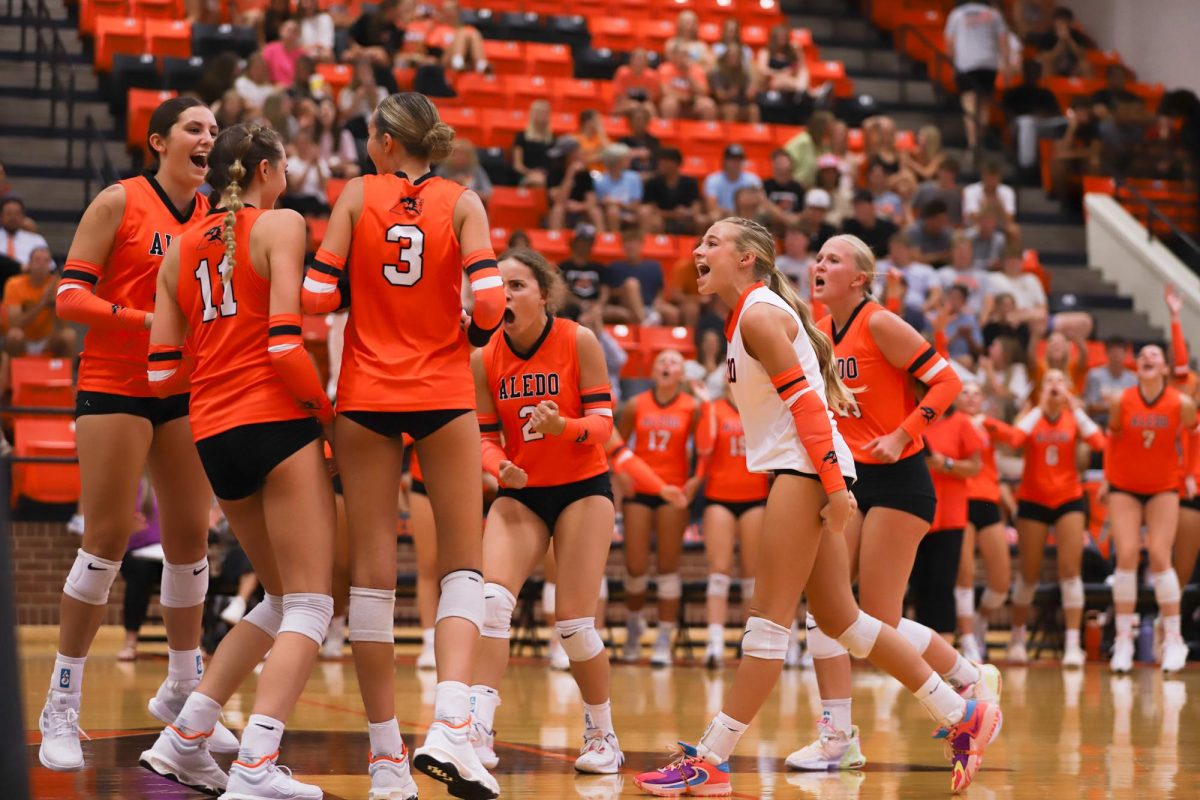 Varsity volleyball players encourage one another at their game against Liberty Christian Aug 12. 