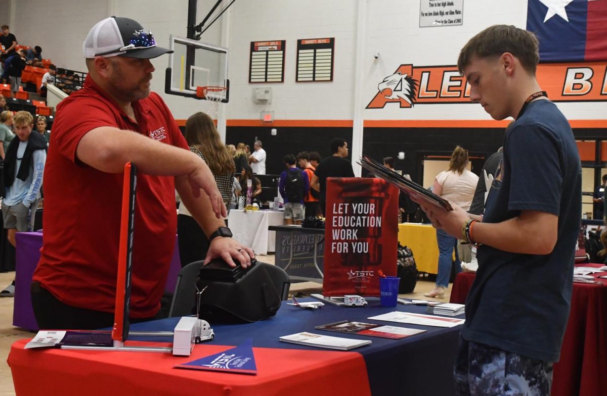 Junior Jack Opstad meets with Texas State Technical College Admissions Counselor at the college fair on Thursday, Oct. 24. 