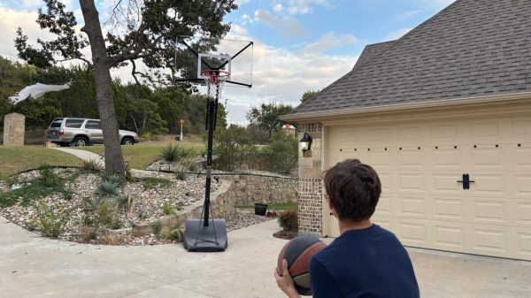 After school, freshman John Stodola practices basketball on a home basketball hoop, Thursday, Oct. 31. Stodola has played baseball for eight year, and he made freshmen A-team this year. “Practicing helps me to make my shots, and get my mind off things that are stressing me out,” Stodola said. 