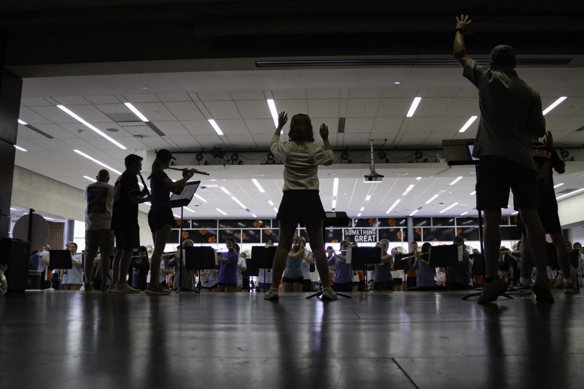 As the band practices in the Daniel Building gym, drum majors guide the chorus on Aug. 2. 