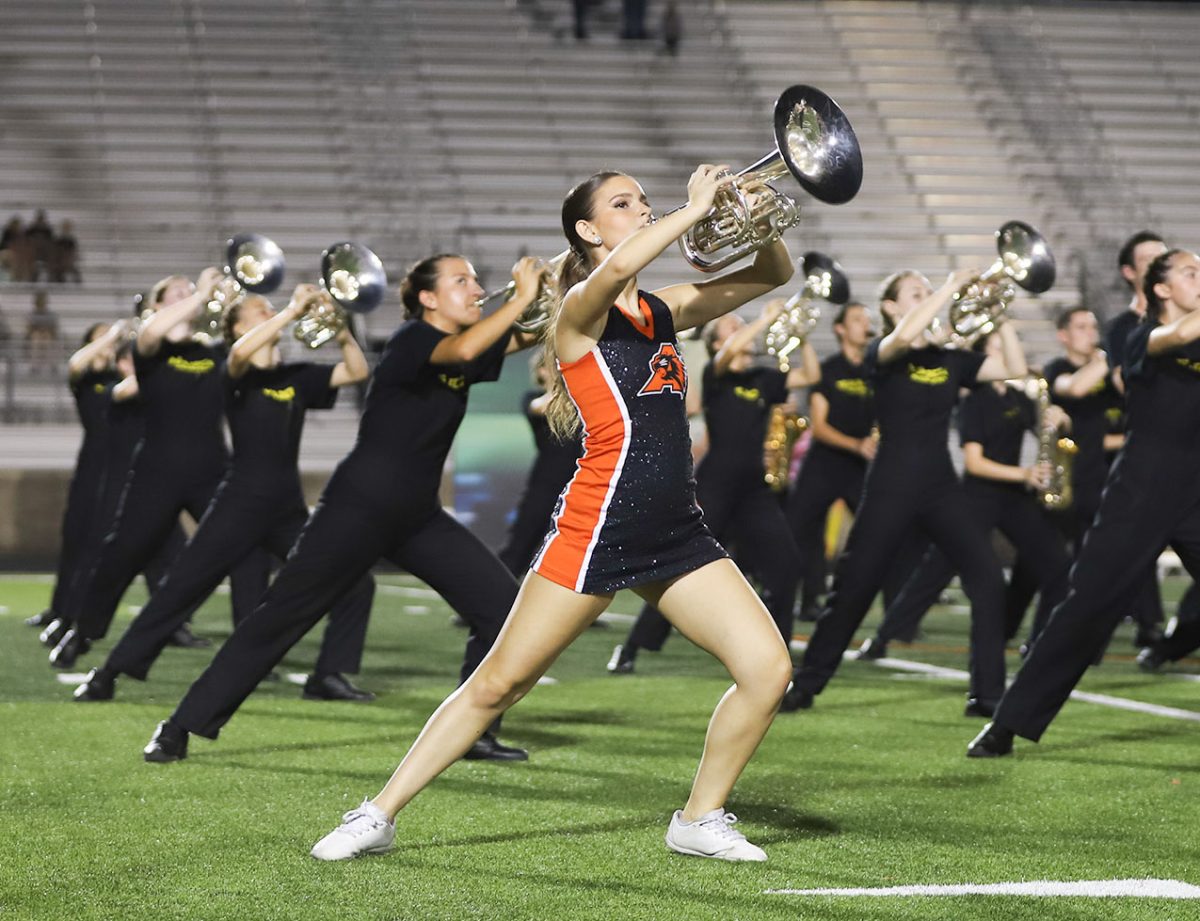 Leading her section, junior Alexis Fisher performs the Bearcat Regiment show "On the Throttle" on Sep. 20. Prior to performing the band show, Fisher also performs with the Bearcats Dance Team during their section of the halftime performances. "On Friday game days, I do pep rallies and sidelines with dance and perform with the band at halftime" Fisher said. "It challenging to remembering choreography for dance and for band it's remembering my dots for the show." Fisher said. 