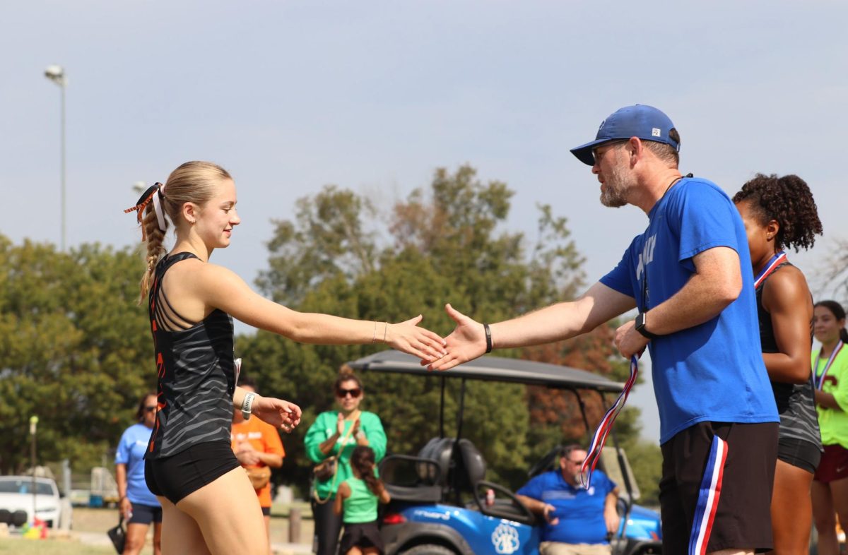 After the match, junior Molly Garrison competes at the Cross Country meet Friday Oct. 11. 