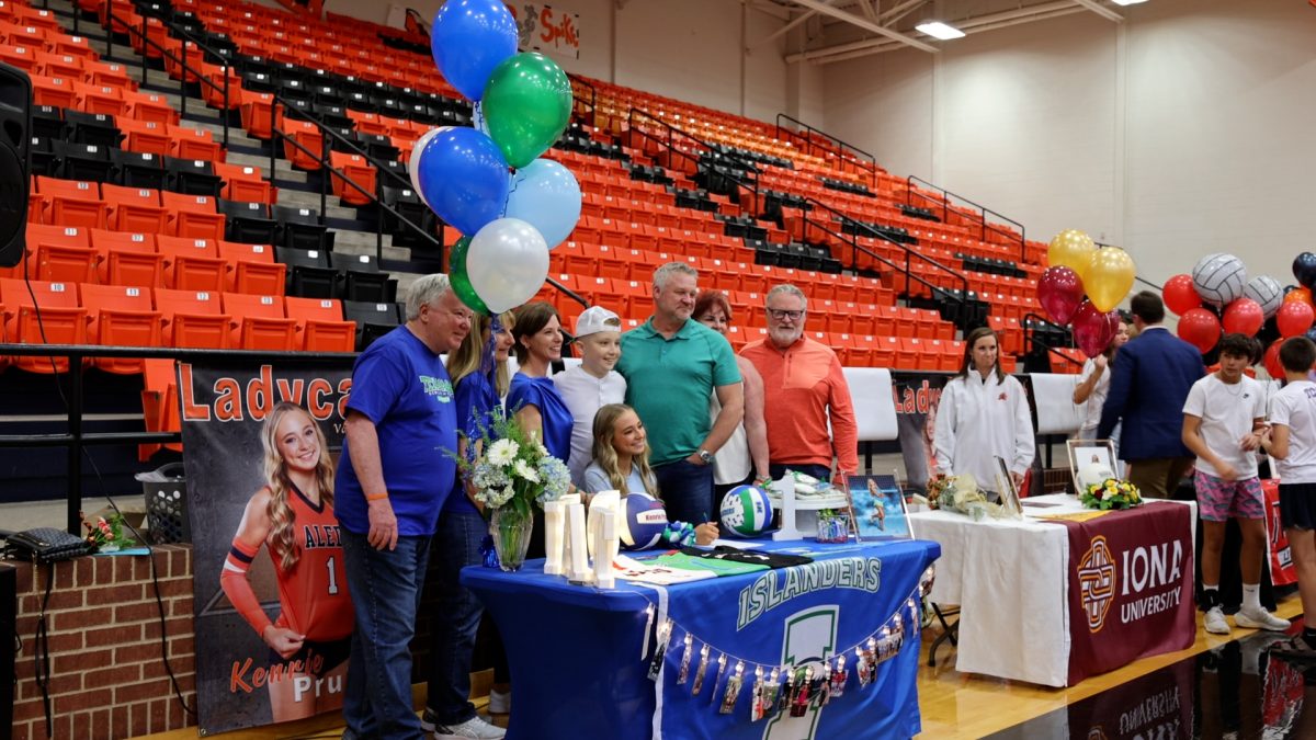 Varsity volleyball senior co-captian Kenrie Pruitt signs to play college volleyball with A&M Corpus Christie at the fall signing Wednesday, Nov. 13, in the high school gym.