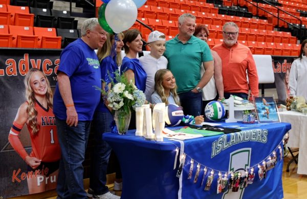 Varsity volleyball senior co-captian Kenrie Pruitt signs to play college volleyball with A&M Corpus Christie at the fall signing Wednesday, Nov. 13, in the high school gym.