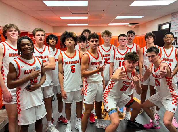 After the varsity boys basketball team defeated Midlothian Heritage High School, players pose for a winning picture Monday, Nov. 25.