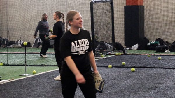 At softball practice, senior pitcher Taylor McKeen works with her team to get ready for the season Friday, Feb. 21.