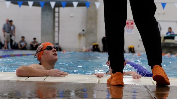 At the regional swim meet Friday, Feb. 7, Bearcat swimmers listens to head swim coach Megan Roberson before their meet.